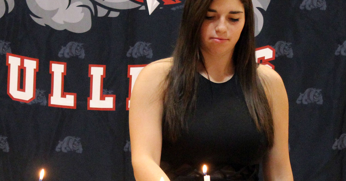 A Golden Plains High School senior participating in a National Honor Society candle ceremony